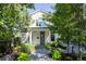Charming home featuring a quaint covered porch with lush front yard landscaping and pea gravel walkway at 4508 Lowell Blvd, Denver, CO 80211