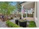 Exterior yard featuring a covered porch, lush landscaping, and a charming fence at 4508 Lowell Blvd, Denver, CO 80211