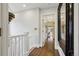 Upstairs hallway with hardwood floors and views into multiple rooms at 4508 Lowell Blvd, Denver, CO 80211