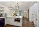 Bright, open kitchen with a center island, stainless steel microwave, and hardwood floors at 4508 Lowell Blvd, Denver, CO 80211
