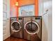 Functional laundry room with side-by-side washer and dryer and a sunlit window at 4508 Lowell Blvd, Denver, CO 80211