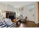 Cozy living room featuring hardwood floors, comfortable seating, a fireplace, and lots of light at 4508 Lowell Blvd, Denver, CO 80211