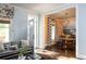 Stylish living room featuring hardwood floors, modern furniture, and an open doorway to the dining room at 4508 Lowell Blvd, Denver, CO 80211