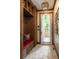 Well-appointed mudroom featuring a built-in bench with storage, coat hooks, and tiled floors at 4508 Lowell Blvd, Denver, CO 80211