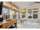 Light-filled sunroom with beautiful windows, travertine floors, and adjacent dining area at 4508 Lowell Blvd, Denver, CO 80211