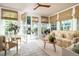 Bright sunroom with tile floor, stylish furnishings, and views of the backyard at 4508 Lowell Blvd, Denver, CO 80211