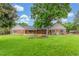 Sprawling backyard featuring a spacious lawn, mature shade trees, and an in-ground flower bed at 3 Glenview Dr, Littleton, CO 80123