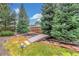 Landscaped backyard with a bridge over a tranquil water feature at 3 Glenview Dr, Littleton, CO 80123