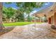 Spacious backyard with patio, lush lawn, mature trees, and charming shed at 3 Glenview Dr, Littleton, CO 80123