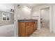 Bathroom with dual sinks, wood cabinetry and tile flooring with adjacent toilet and bedroom at 3 Glenview Dr, Littleton, CO 80123