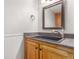 Bathroom featuring stylish vanity with a dark countertop and modern faucet at 3 Glenview Dr, Littleton, CO 80123