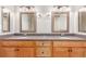 Bathroom with a double vanity, framed mirrors, granite counters, and ample cabinet space at 3 Glenview Dr, Littleton, CO 80123