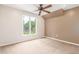 Bedroom featuring neutral walls, carpet, ceiling fan and window view of the outdoors at 3 Glenview Dr, Littleton, CO 80123