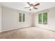 Bright bedroom featuring neutral paint, carpet floors, and large windows overlooking the backyard at 3 Glenview Dr, Littleton, CO 80123