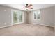 Spacious bedroom with neutral walls, ceiling fan and a sliding glass door leading to the outside at 3 Glenview Dr, Littleton, CO 80123
