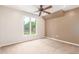 Bright bedroom featuring a large window overlooking the lush outdoor landscaping at 3 Glenview Dr, Littleton, CO 80123