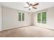 Inviting bedroom featuring two large windows offering peaceful green views at 3 Glenview Dr, Littleton, CO 80123