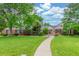 Charming brick home with a lush green lawn, mature trees, and inviting walkway at 3 Glenview Dr, Littleton, CO 80123