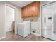 Practical laundry room featuring a washing machine, ample cabinets, and easy access to other rooms at 3 Glenview Dr, Littleton, CO 80123
