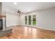 Cozy living room with hardwood floors, a ceiling fan, and french doors leading to the backyard at 3 Glenview Dr, Littleton, CO 80123