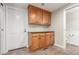 Convenient mud room with granite countertops, wooden cabinets, and access to an adjacent bathroom at 3 Glenview Dr, Littleton, CO 80123