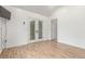Bright room with laminate wood flooring, glass doors, and neutral wall paint at 3 Glenview Dr, Littleton, CO 80123