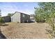 Large backyard features dry grass, trees, wood fence, and an air conditioning condenser at 19335 E Batavia Pl, Aurora, CO 80011