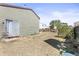 Backyard features dry grass, a sliding glass door, and a wood fence in the background at 19335 E Batavia Pl, Aurora, CO 80011