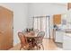 Bright dining area with a round wooden table and natural light from the nearby window at 19335 E Batavia Pl, Aurora, CO 80011