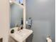 Small powder room with white sink and blue walls at 1537 W 43Rd Ave, Denver, CO 80211