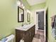 Double vanity bathroom with light green walls and grey flooring at 1537 W 43Rd Ave, Denver, CO 80211