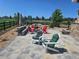 Relaxing backyard patio featuring a fire pit with Adirondack chairs and outdoor seating areas with stone landscaping at 23696 E Del Norte Pl, Aurora, CO 80016
