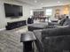 Finished basement with a large sectional couch, TV, and game area featuring a pool table at 23696 E Del Norte Pl, Aurora, CO 80016