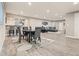 Open basement area showcasing a dining table, bar with seating, and a comfortable living space at 23696 E Del Norte Pl, Aurora, CO 80016