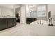Bright bathroom featuring dual vanities, a soaking tub, mosaic tile accents, and an adjacent bedroom at 23696 E Del Norte Pl, Aurora, CO 80016