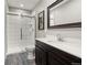 Modern bathroom features a glass enclosed shower, white quartz countertops and a dark wood vanity at 23696 E Del Norte Pl, Aurora, CO 80016