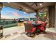 Inviting covered patio with an outdoor fireplace, ceiling fans, and a dining set, perfect for relaxing outdoors at 23696 E Del Norte Pl, Aurora, CO 80016