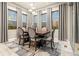 Dining room with modern chandelier, seating for six, and light colored plank flooring at 23696 E Del Norte Pl, Aurora, CO 80016