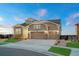 A craftsman style home with a three-car garage, stone accents, and a well-manicured lawn at 23696 E Del Norte Pl, Aurora, CO 80016