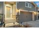 Close up of craftsman style home featuring a three-car garage, and stone accents at 23696 E Del Norte Pl, Aurora, CO 80016