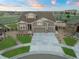 Attractive home with a three-car garage, concrete driveway, and a beautifully landscaped front yard at 23696 E Del Norte Pl, Aurora, CO 80016
