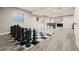 Spacious basement game room features oversized chess set and a partial kitchen area with dark cabinets at 23696 E Del Norte Pl, Aurora, CO 80016