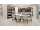 Modern kitchen with stainless steel appliances, a center island with seating, and dark cabinets at 23696 E Del Norte Pl, Aurora, CO 80016