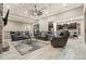 Spacious living room featuring coffered ceilings, stone fireplace and open concept design at 23696 E Del Norte Pl, Aurora, CO 80016