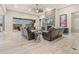 Beautiful living room with a stone fireplace, ceiling fan, and sliding glass doors offering an indoor/outdoor living at 23696 E Del Norte Pl, Aurora, CO 80016