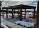 Community outdoor pavilion with tables and benches, perfect for gatherings, set in a snowy winter landscape at 23696 E Del Norte Pl, Aurora, CO 80016