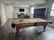 Spacious recreation room with a pool table, foosball table, game table and storage shelves for entertaining at 23696 E Del Norte Pl, Aurora, CO 80016