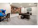 Basement recreation room includes a classic arcade game, sofa, television, and decorative wall art at 23696 E Del Norte Pl, Aurora, CO 80016