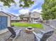 Landscaped backyard with a deck, fire pit, shed, and ample space for relaxation and entertainment at 11395 E 116Th Dr, Commerce City, CO 80640