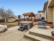 This backyard features a hot tub, patio, shed, picnic table, and other amenities, making it perfect for entertaining at 11395 E 116Th Dr, Commerce City, CO 80640